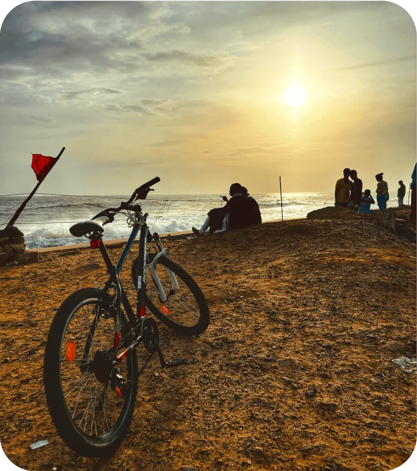 photograph of my mountain bike at the beach with visitors enjoying the evening view